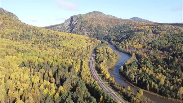 View of the Railway and Mountain River Flowing Along the Forest in the Distance on the Horizon of