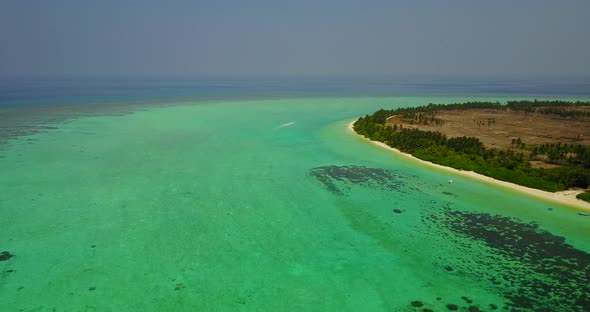 Tropical overhead island view of a paradise sunny white sand beach and aqua turquoise water backgrou