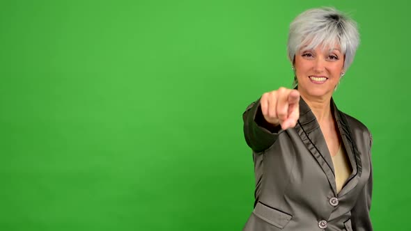 Business Middle Aged Woman Points To the Camera - Green Screen - Studio