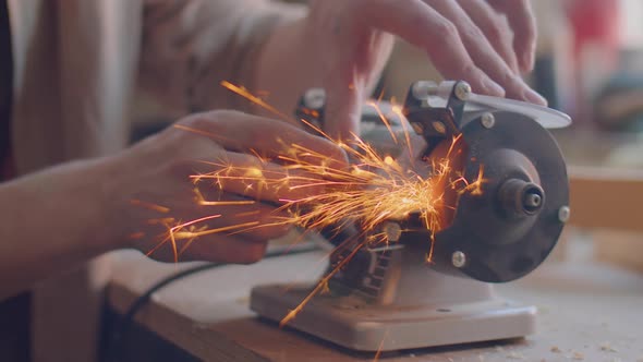 Carpenter Sharpening Knife with Grinding Jig in Workshop