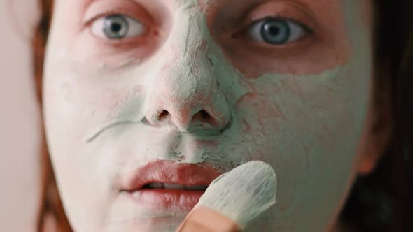 Home Woman Applying Cosmetic Face Mask in Her Bathroom