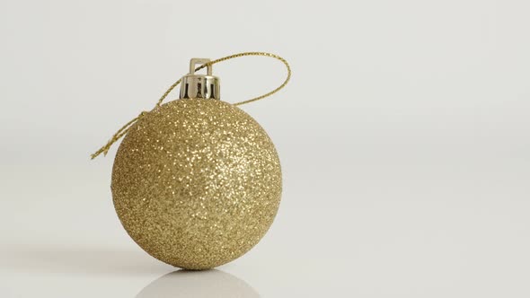 Golden bauble with sequins close-up 4K 2160p 30fps UltraHD tilting  footage - Christmas ornament in 