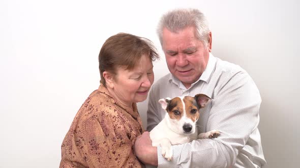 An Elderly Couple with a Dog on a White Background