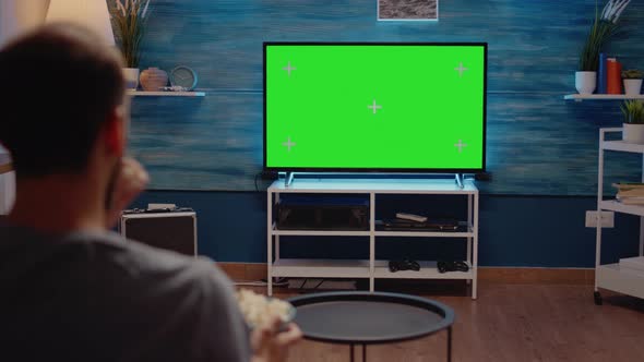 Man Watching Green Screen TV in Living Room