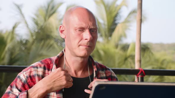 Handsome Man Dressing the Glasses and Start Working on Laptop Outdoor