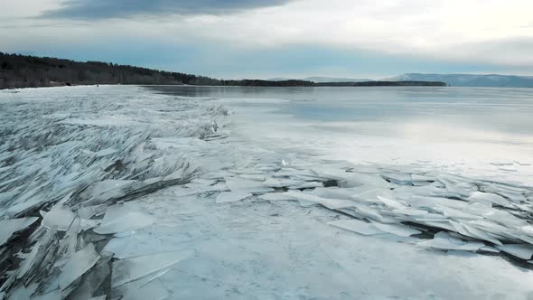 Winter Landscape on the River Bank. Sharp Ice at the Shore, Sticking Out of the Water. Winter and