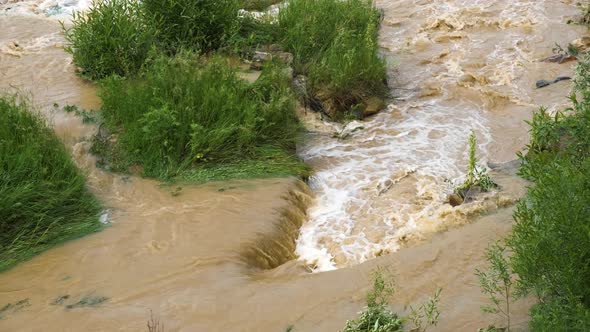 Dirty River with Muddy Water in Flooding Period During Heavy Rains in Spring