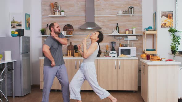 Funny Couple Dancing in Kitchen