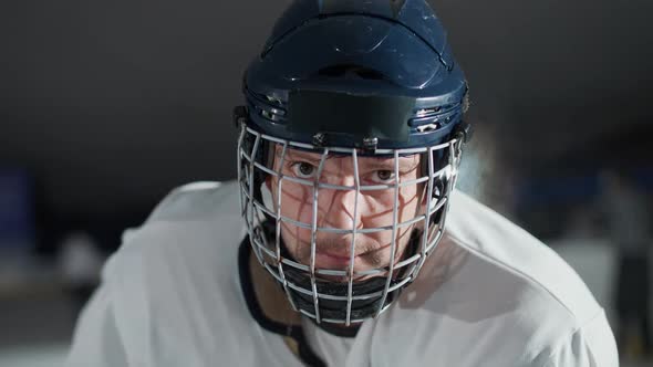 Handheld Portrait of a Forward Hockey Player Seriously Looking at the Camera Steam Coming From the