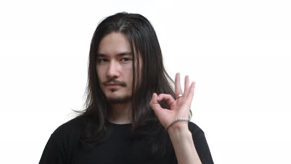 Closeup of Handsome Confident Eastasian Man with Long Dark Hair Piercing and Moustache Wearing Black