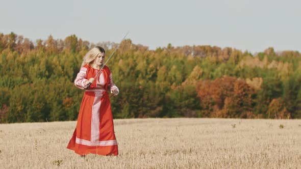 Feisty Woman in Red Dress Training on the Field - Trains with a Sword and Ending Up Posing