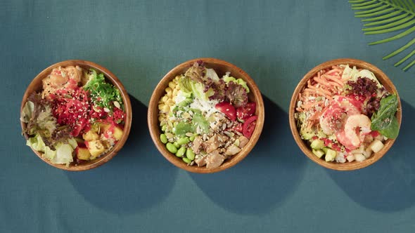 Putting Sauces to Cooked Poke Bowls on Table Top View