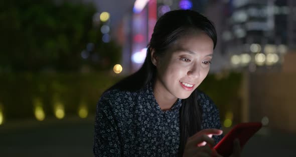 Young Businesswoman use of mobile phone in city at night