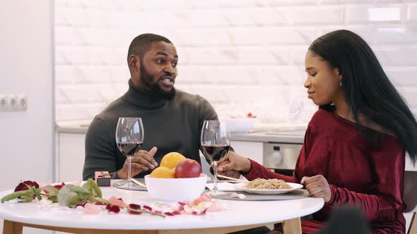 Young Couple Having Dinner at Home and Celebrating Saint Valentine