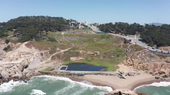 Wide reverse pullback aerial shot of the ruins of the Sutro Baths in Land's End, San Francisco. 4K