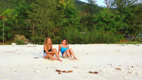 Tourists happy together on paradise island beach voyage by blue green ocean with white sand backgrou