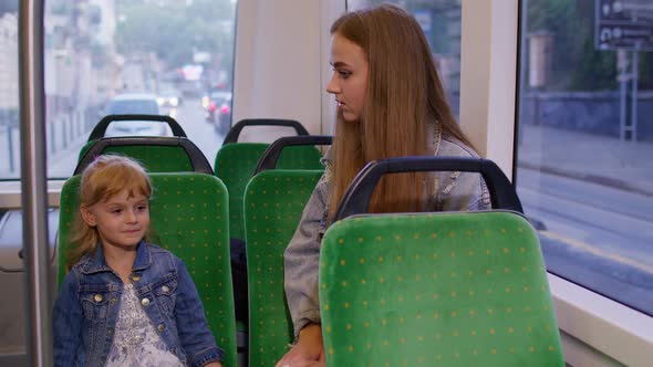 Stressed Annoyed Mother Nagging Shouting at Rebellious Kid Girl Child in Public Bus Transport