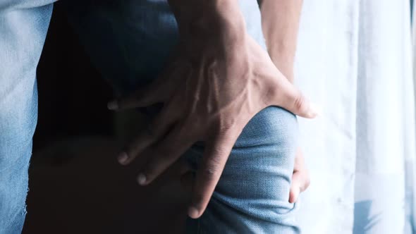 Close Up on Man Suffering Knee Joint Pain