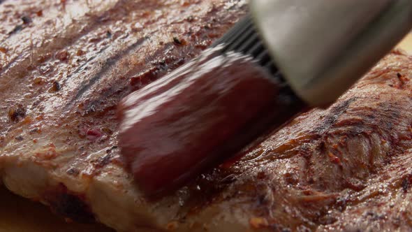 Super Closeup of the Juicy Appetizing Ribs Spread with Tomato Sauce