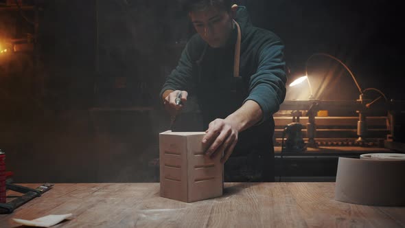 The Carpenter Guy Blows Dust Off the Finished Wooden Product a House for Birds and Animals