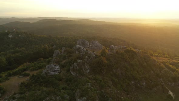 Drone Flight Over Rocky Hilltop At Sunset