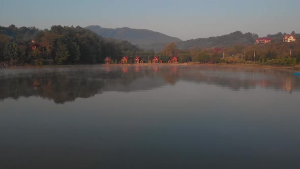 Misty Sunrise Over Lake at Alpine Countryside