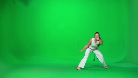 Woman with Long Hair Practicing Capoeira on Chroma Key Studio. Slow Motion.