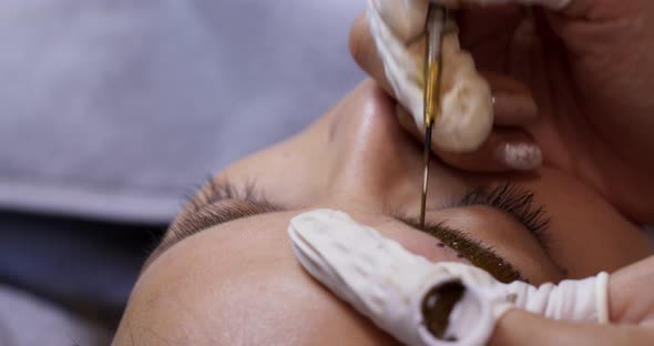 Close up of cosmetologist making microblading procedure