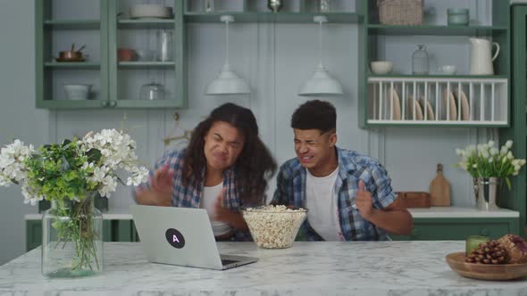 20s Dissatisfied African American Couple Watching Sports Game Online Using Laptop