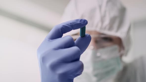 Video of capsule in hands of a laboratory technician. Shot with RED helium camera 