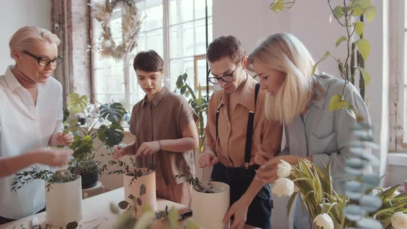 Women and Male Florist Making Flower Compositions in Hatboxes on Masterclass