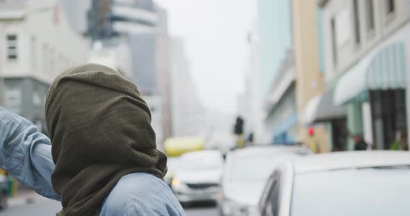 Woman wearing hijab looking for a taxi