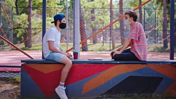 Attractive Guys in the Park with a Protective Mask