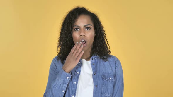 African Girl in Shock Isolated on Yellow Background Wondering