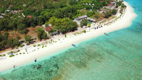 Aerial drone tourism of idyllic coast beach journey by blue sea with white sandy background of a day