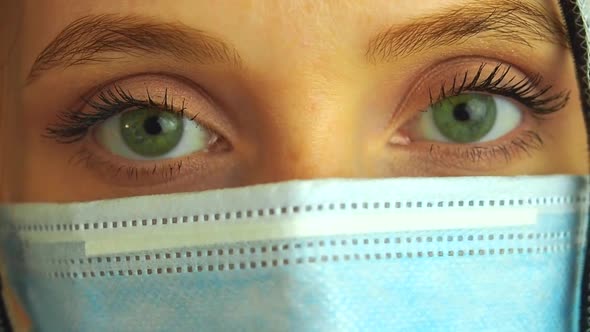 Virologist Woman in Chemical Protection Mask Glasses and Gloves Holding Potential Vaccine at the Lab