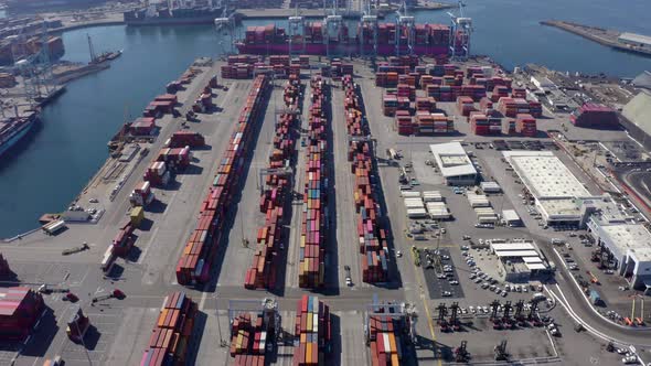 Cargo containers in busy port, aerial. Drone shot. 