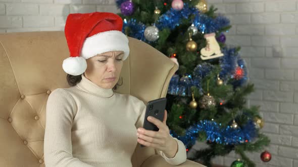 Stressed Woman with Phone in Christmas Room