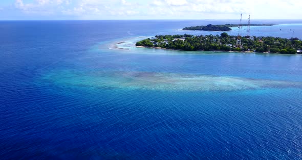 Beautiful flying clean view of a white sandy paradise beach and aqua turquoise water background in h