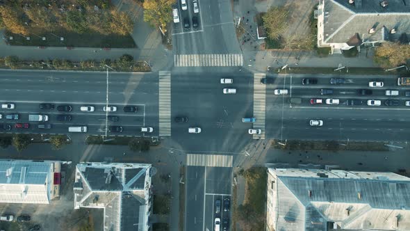 A Wide Road Intersection in the Morning Cars Start Moving at a Traffic Light