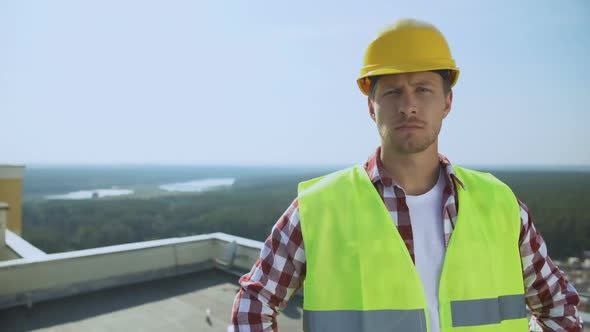 Professional Male Builder in Helmet Looking Camera, Construction Industry, Work