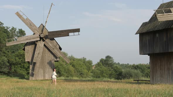 Happy girl near windmills 