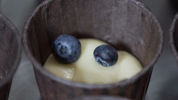 Hand Decorating Cup Cake with Blueberry. Slow Motion