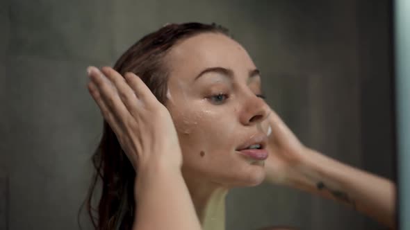 Portrait of a Woman Washing Her Hair with Shampoo in the Shower