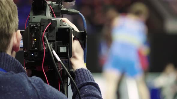 Cameraman with a Camera in Wrestling Competitions. Close-up.