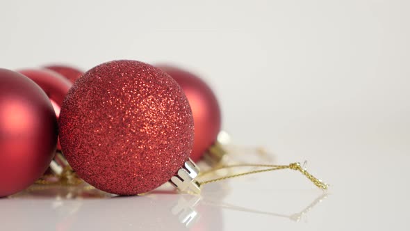 Decorative red baubles on white background 4K titling video