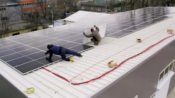 Solar Technician Installing Solar Panels on House Roof