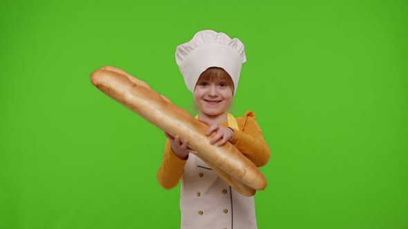Child Girl Kid Cook Chef Baker Sniffing Two Fresh Baguettes Smiling Waving Head in Agreement