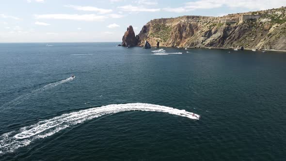 Happy People Swim on Air Mattress Behind a High Speed Water Bike