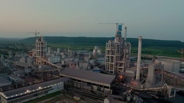 Cement Plant with High Factory Structure at Industrial Production Area at Sunset